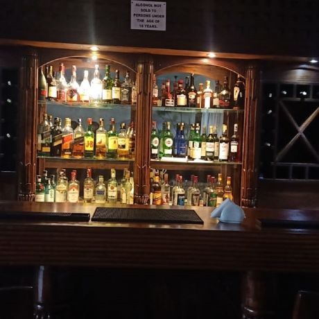 A Bar With Many Bottles Of Alcohol